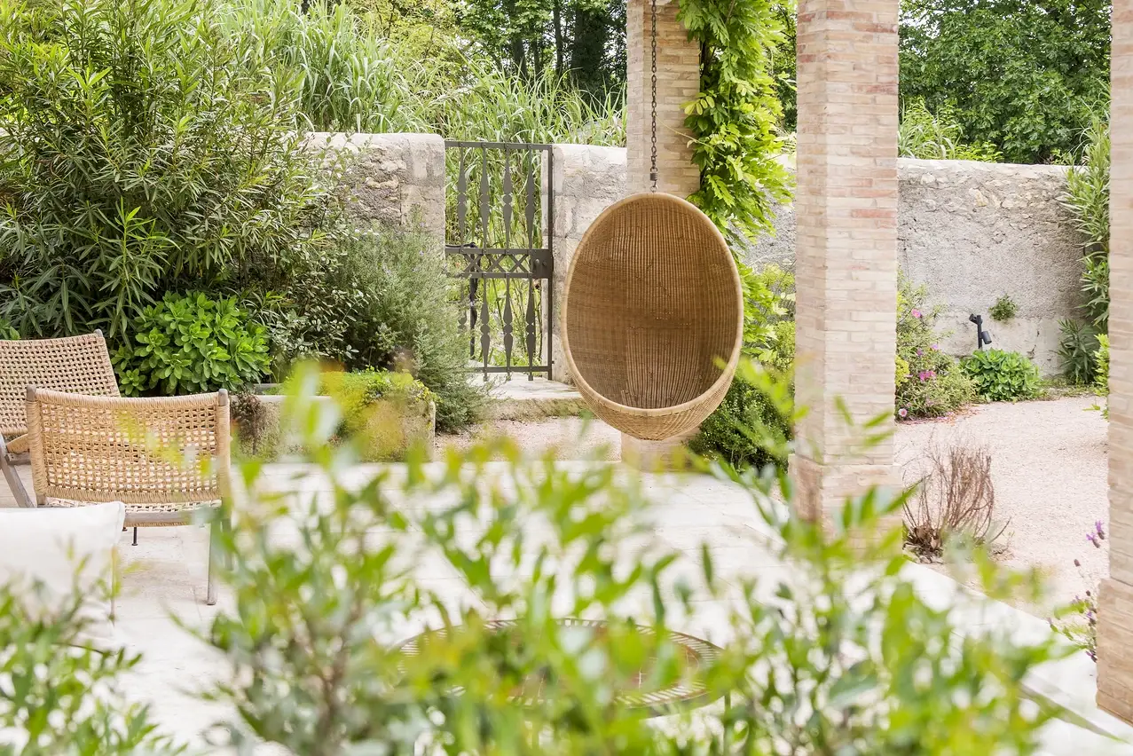Shady place and a hanging swing chair in the garden